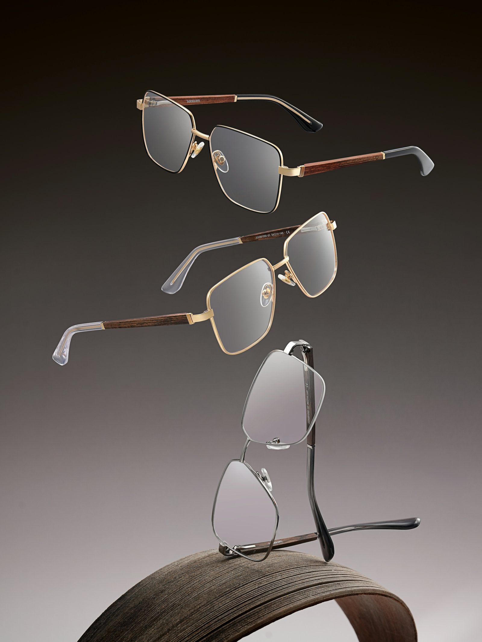 Three modern eyeglass frames laid side by side