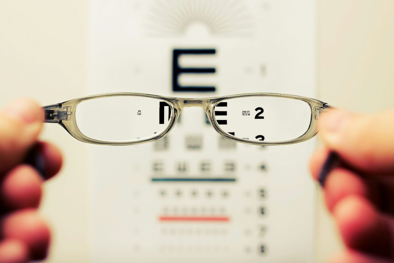 Hands holding a pair of glasses